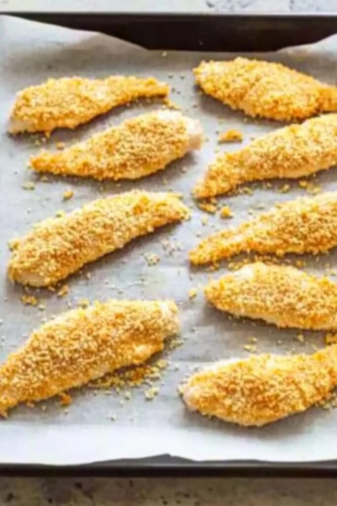 step 1: Dip a chicken tender into the egg mixture, then dip it in the dry ingredients and transfer to the baking sheet