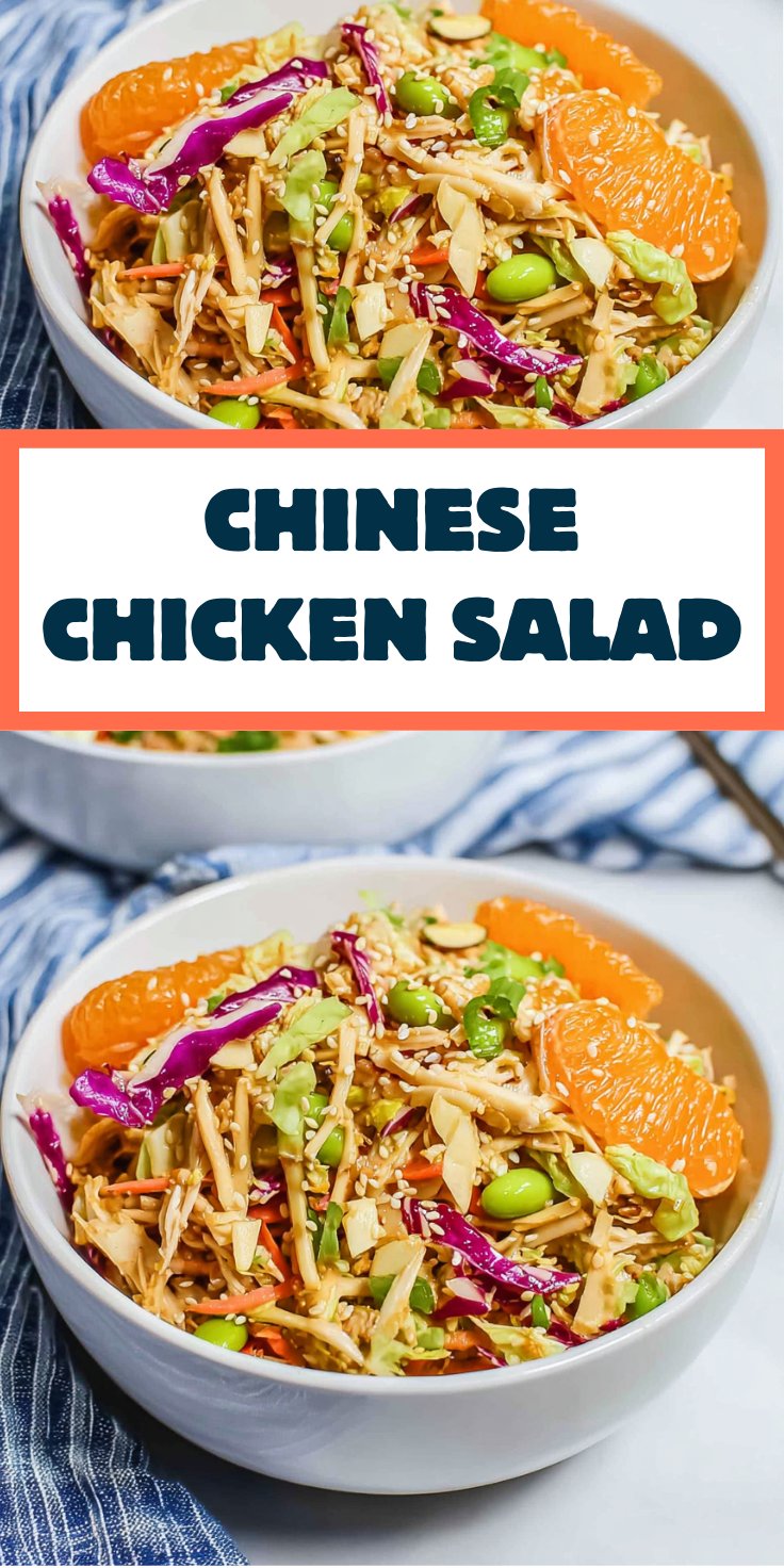 White bowl filled with Chinese chicken salad topped with mandarins, sesame seeds, cabbage, and shredded chicken.