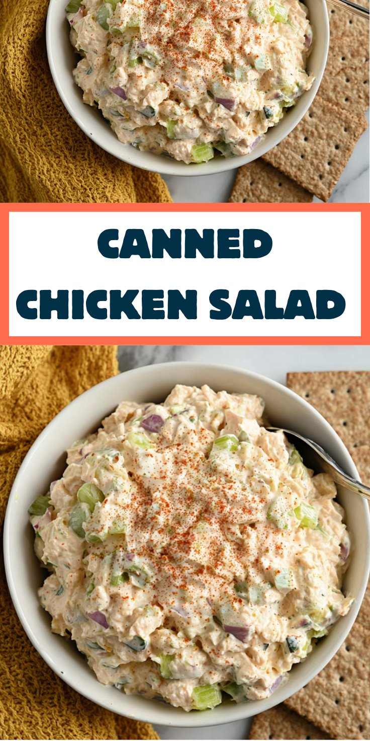 Freshly mixed chicken salad in a glass bowl with spatula.